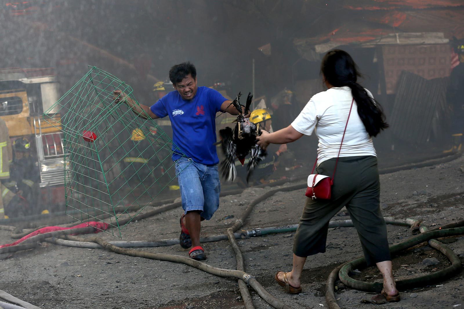 HELPING HAND. A woman helps her husband, who was trying to salvage everything that could be saved from their burning home. 