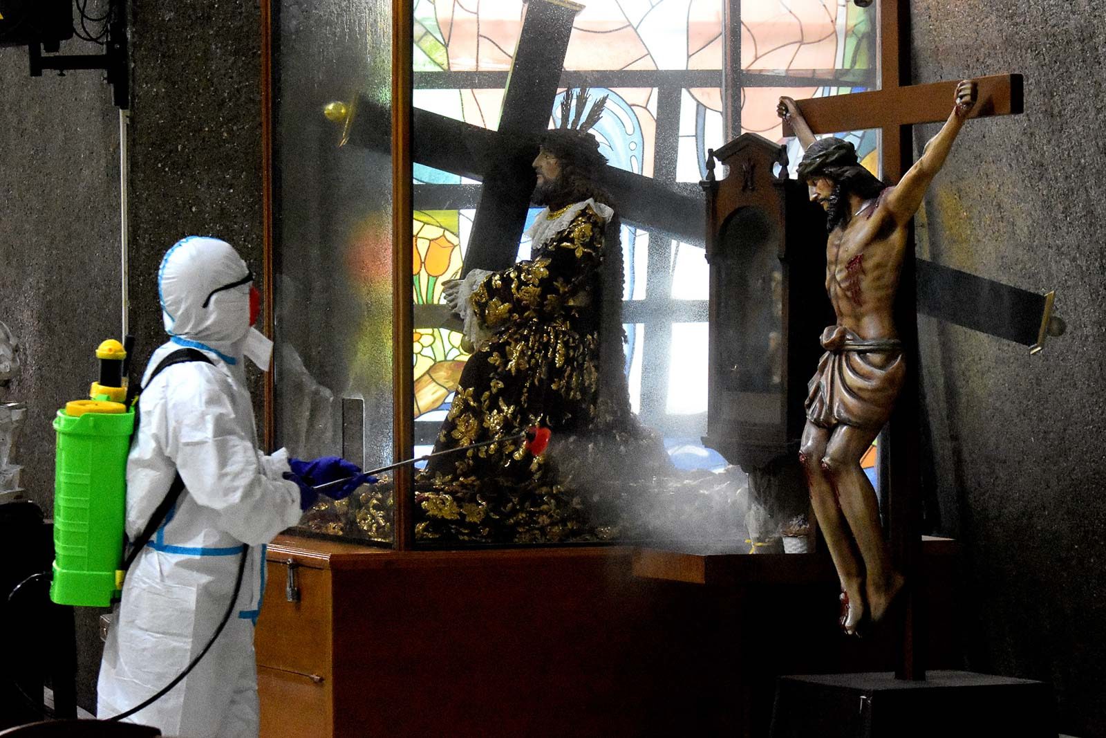 DISINFECTION. Workers disinfect a Catholic church in Quezon City on May 19, 2020, as they prepare for the resumption of public Masses once coronavirus measures are eased. Photo by Angie de Silva/Rappler  
