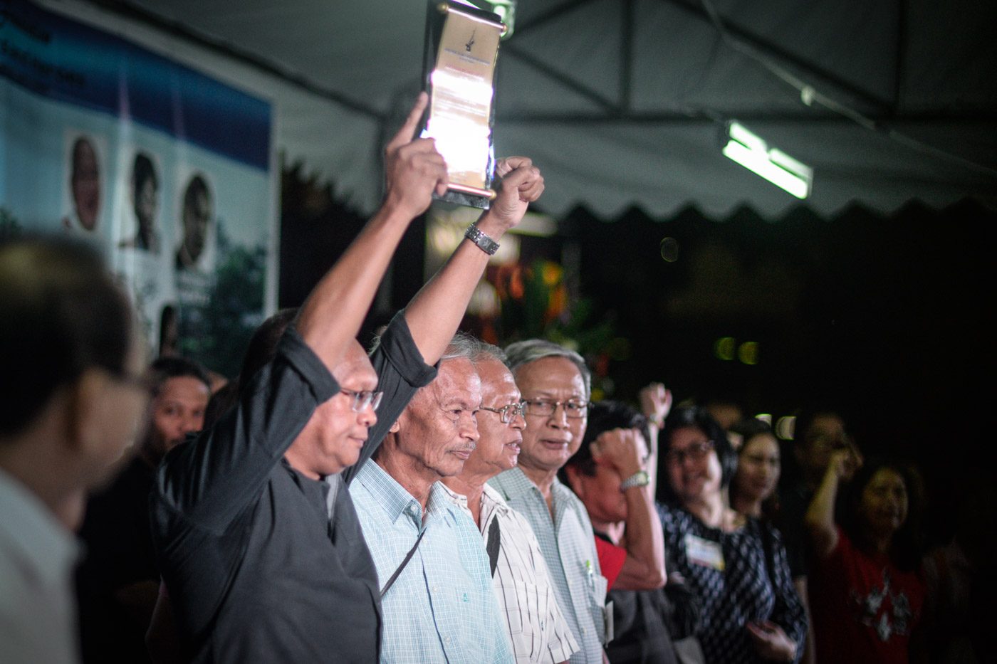 Mel Cortez raises his clenched fist after receiving the citation for his fallen brother fallen and trade union organizer Hernando Cortez from the Bantayog ng mga Bayani Foundation 