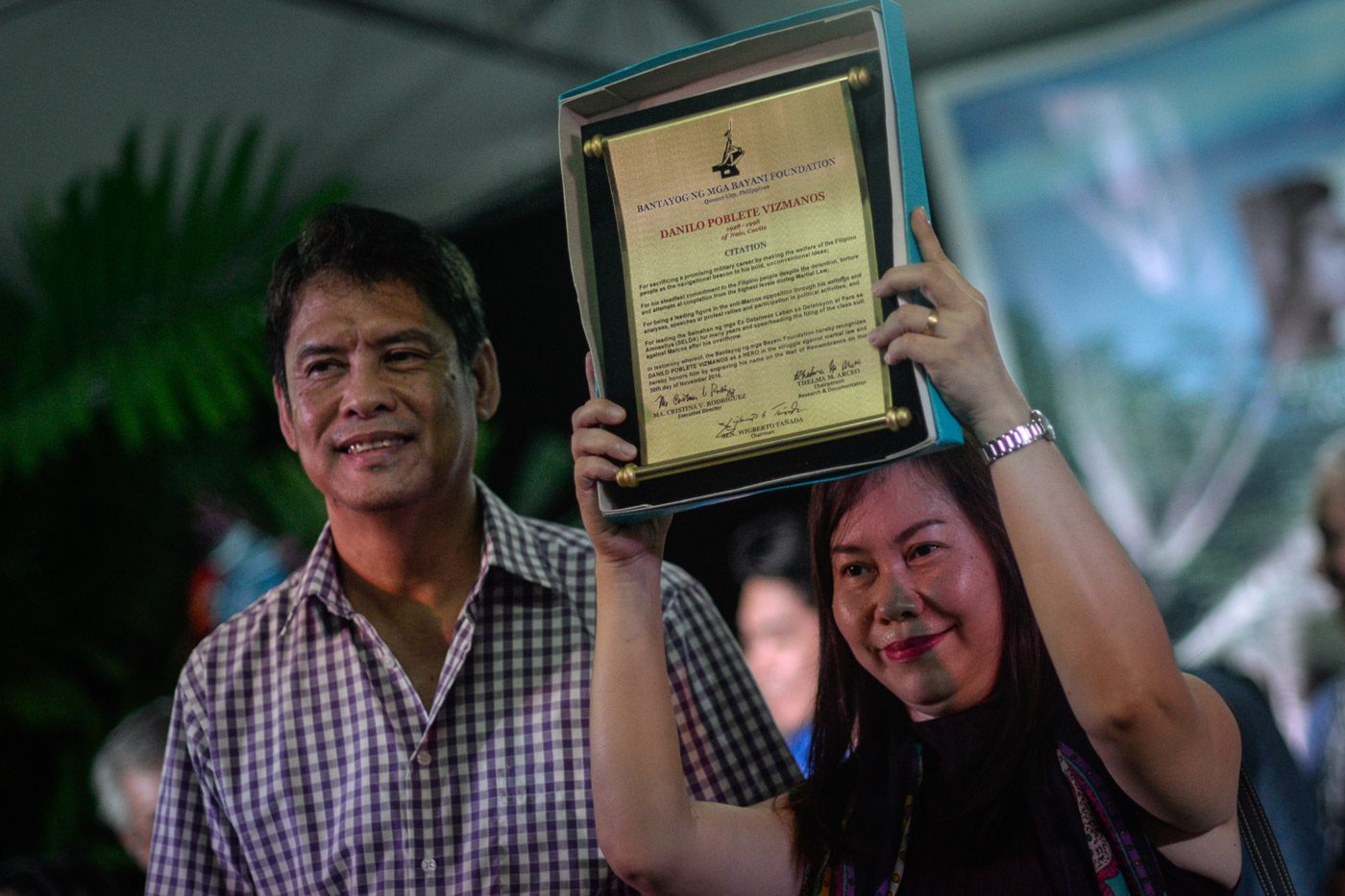 Relatives of former soldier turned rebel Danilo Vizmanos show the citation awarded to them by the Bantayog ng mga Bayani Foundation 