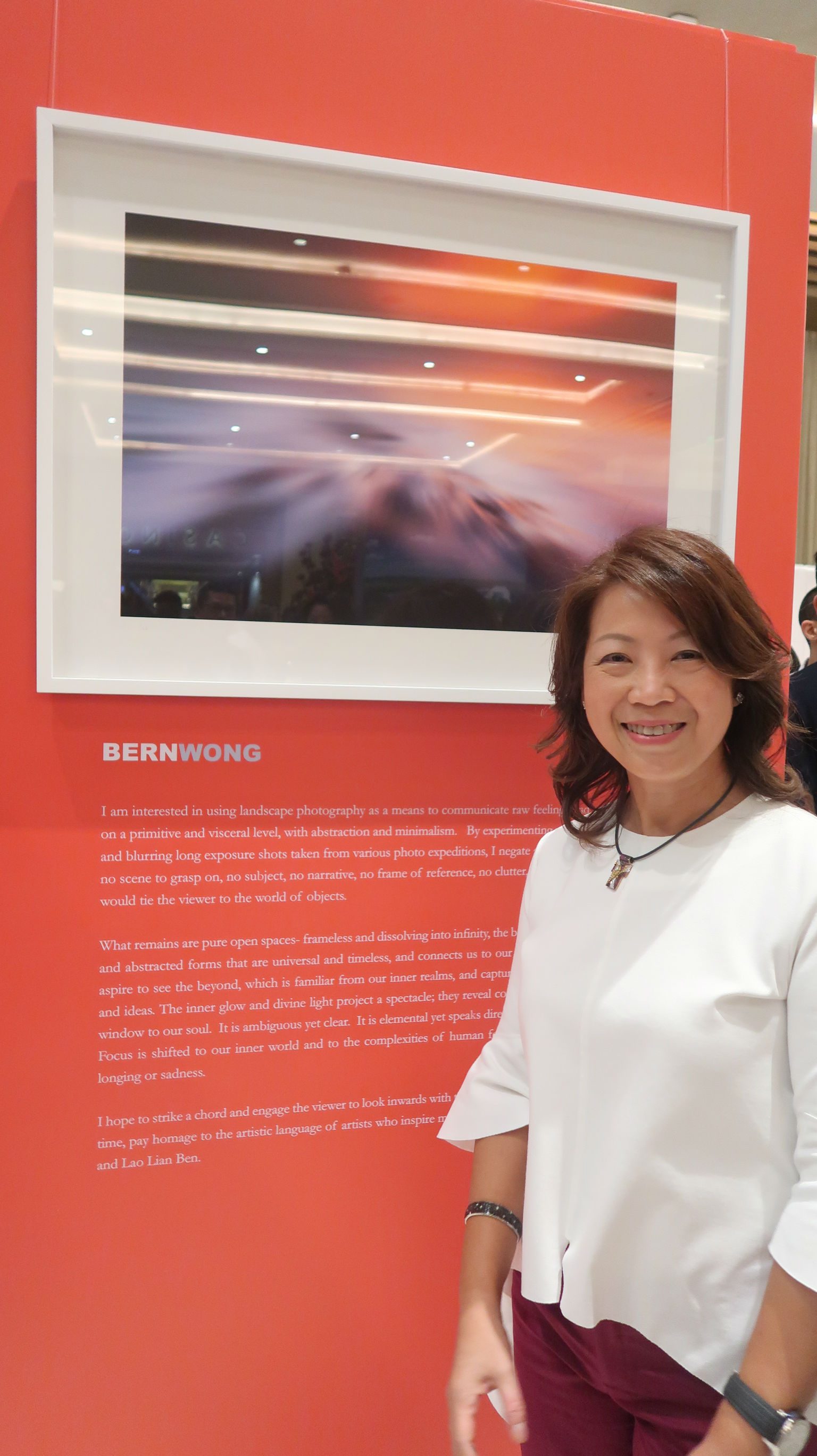 ARRIVALS AND DEPARTURES. Bern Wong poses to her photo at the 'Seeing Beyond' exhibit. Photo by Precious del Valle/Rappler 