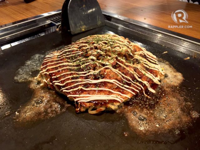 HIROSHIMA YAKI MIX. The hiroshima-style okonomiyaki – with noodles and friend egg – on the griddle. Photo by Vernise L. Tantuco/Rappler.com 