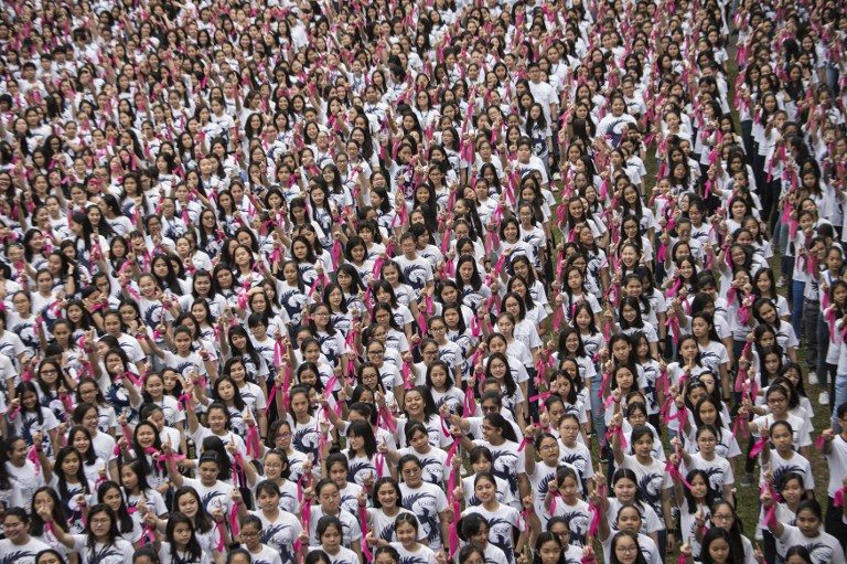 ONE BILLION RISING. Students of St Scholastica's College gesture the number one sign as they dance to take part in the 'One Billion Rising' global movement in Manila on February 14, 2018. Photo by Ted Aljibe/AFP   