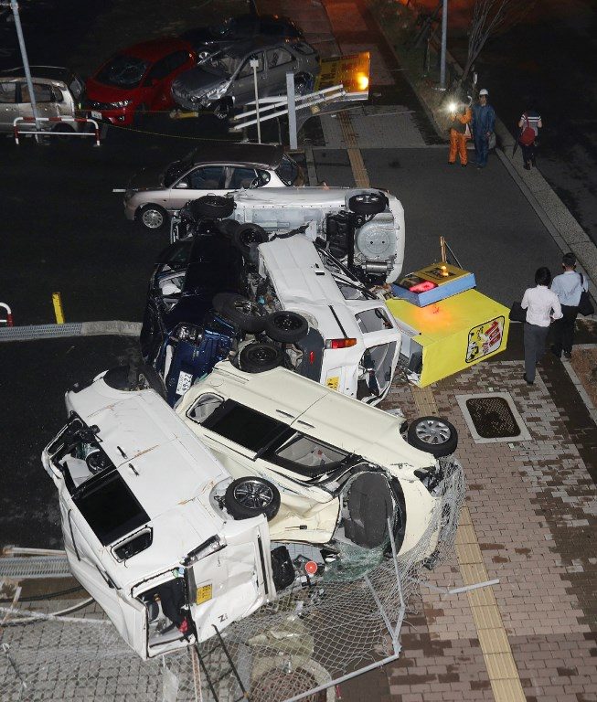 Damaged vehicles blown by strong winds from Typhoon Jebi are seen in Osaka on September 4, 2018. Photo by Jiji Press/AFP 