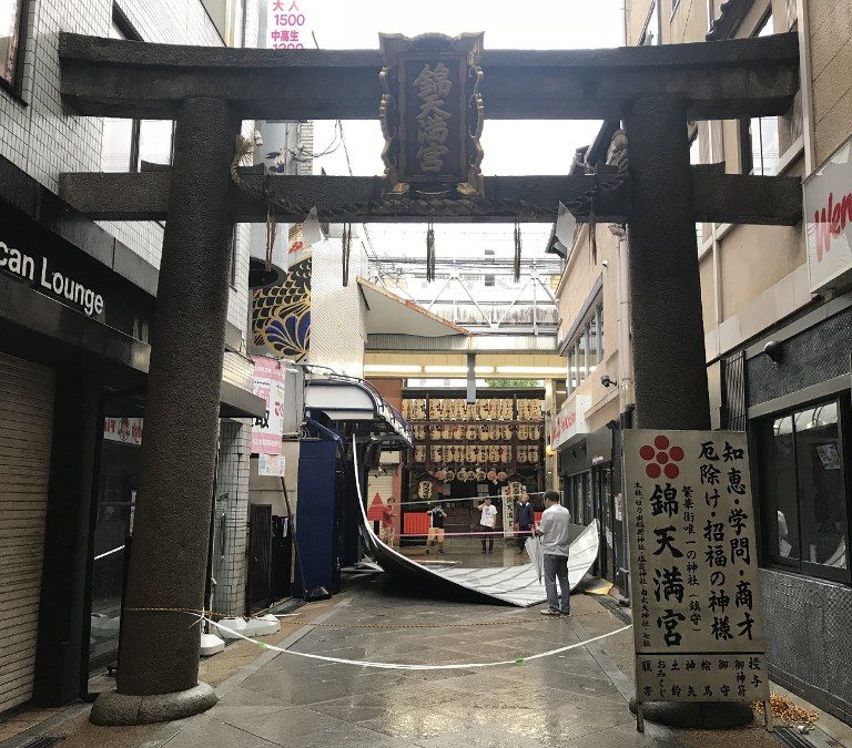 A fallen roof panel is seen past the entrance to the Nishiki Tenmangu shrine at the Shin-Kyogoku shopping district in Kyoto on September 4, 2018, as Typhoon Jebi made landfall around midday in southwestern Japan. Photo by Jiji Press/AFP 