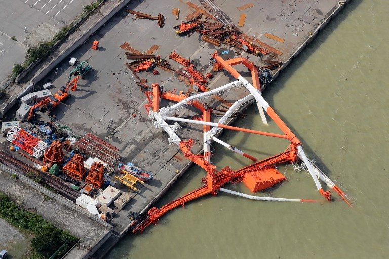 An aerial view from a Jiji Press helicopter shows a crane that toppled due to strong winds in Nishinomiya city, Hyogo prefecture on September 5, 2018. Photo by Jiji Press/AFP 