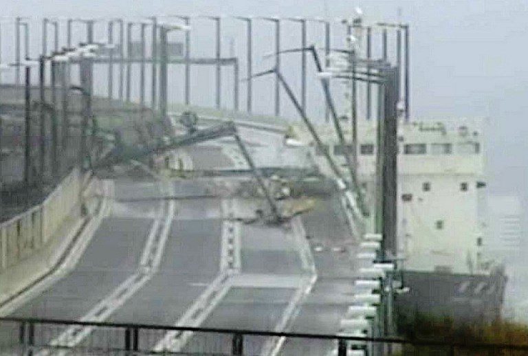 A tanker ship (R) that had smashed into a bridge connecting the city of Izumisano with Kansai international airport, with the top part of the ship knocking away a part of the bridge, as Typhoon Jebi made landfall around midday in southwestern Japan. Photo by Jiji Press/AFP 