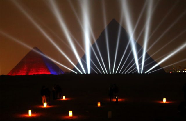 Egyptians celebrate in front of the Pyramids during New Year's Eve in Giza, Egypt. Photo by Khaled Elfiqi/EPA 