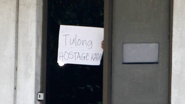 Sign outside INC building: ‘Tulong, hostage kami’