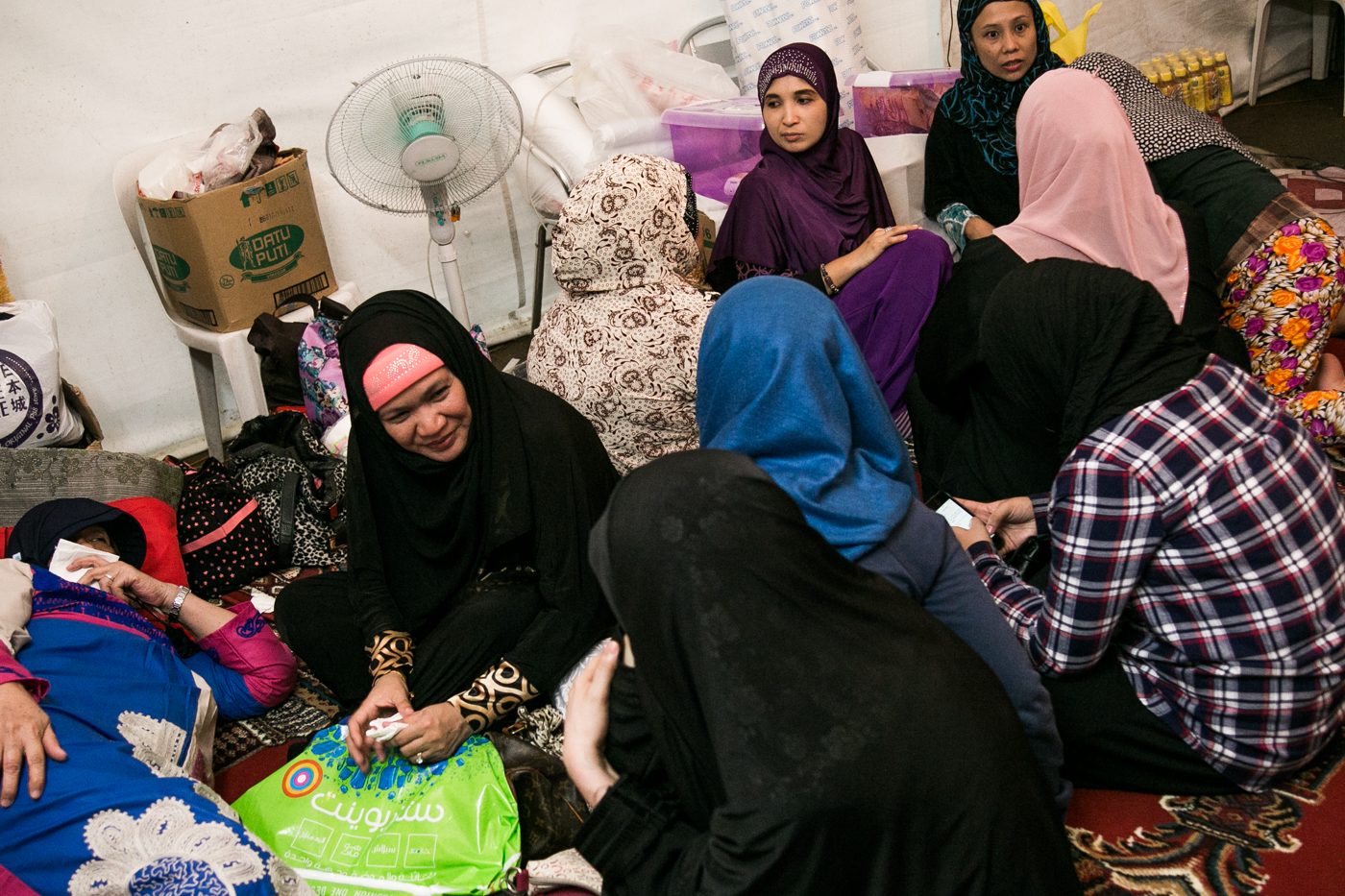 Fatima, a convert and founder of Ramadan Tent, talks to her friends inside the prayer area before Iftar, the nightly breaking of the fast.  