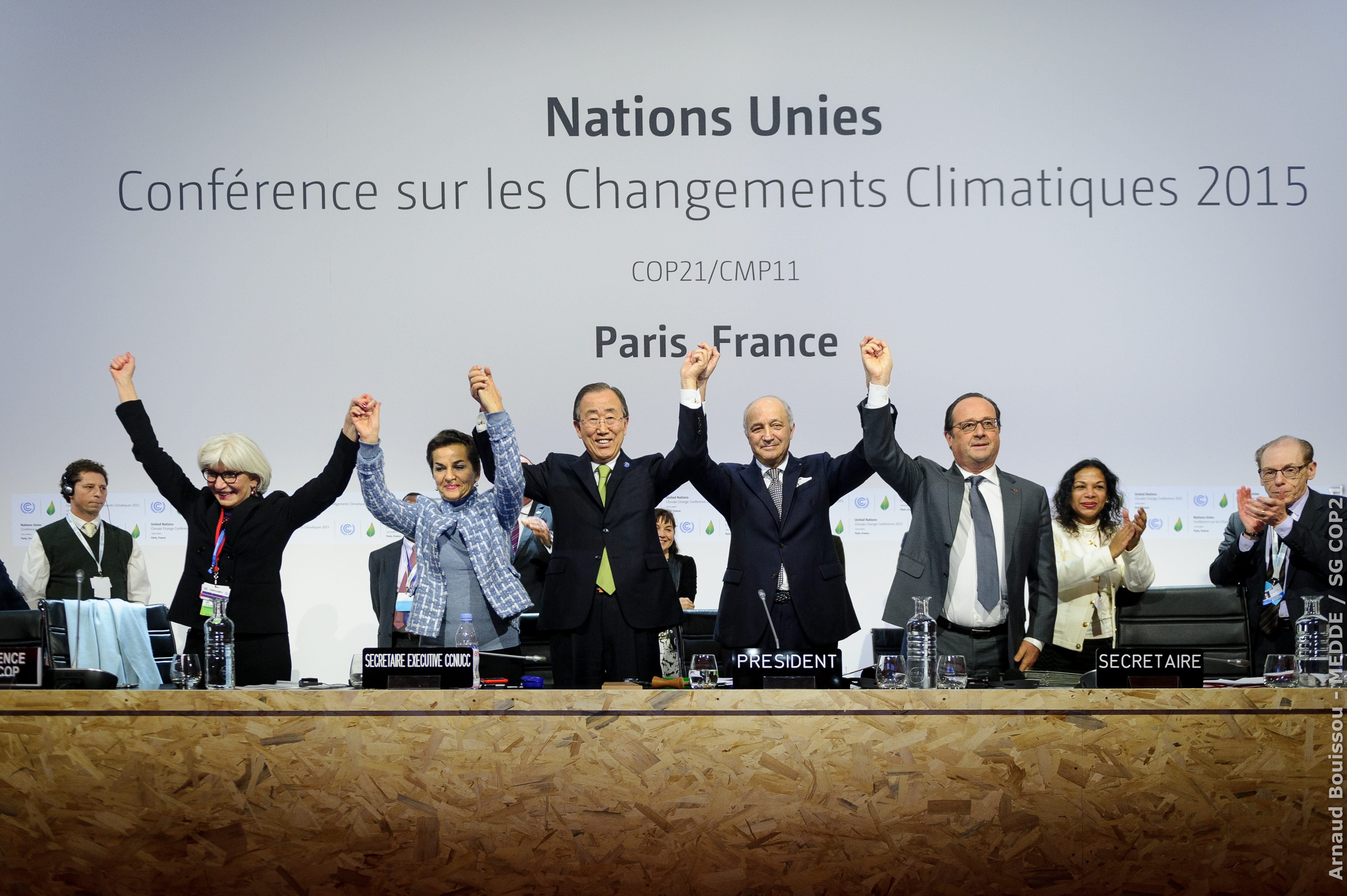 The top leaders of the UN climate change conference raise their hands after the approval of the Paris Agreement, at Le Bourget, France, December 12, 2015. Arnaud Bouissoi/COP21 