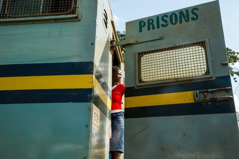 PARDONED. A female inmate takes one last look at the prison as she is released from the Chikurubi Prison in Harare on March 22, 2018. President Emmerson Mnangagwa pardoned at least 3,000 prisoners to clear out overpopulated jails. Photo by Jekesai Njikizana/AFP 