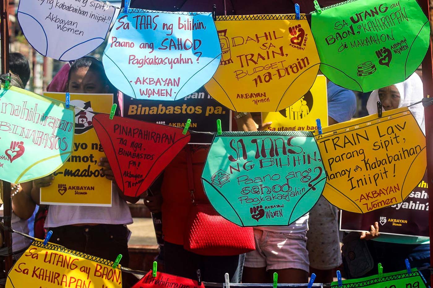 PANTY PROTEST. Members of Akbayan women hold a symbolic 'panty protest' at the Boy Scout Circle in Quezon City on March 23, 2018, highlighting issues of misogyny and the rising prices of commodities due to the TRAIN Law. Photo by Darren Langit/Rappler 
