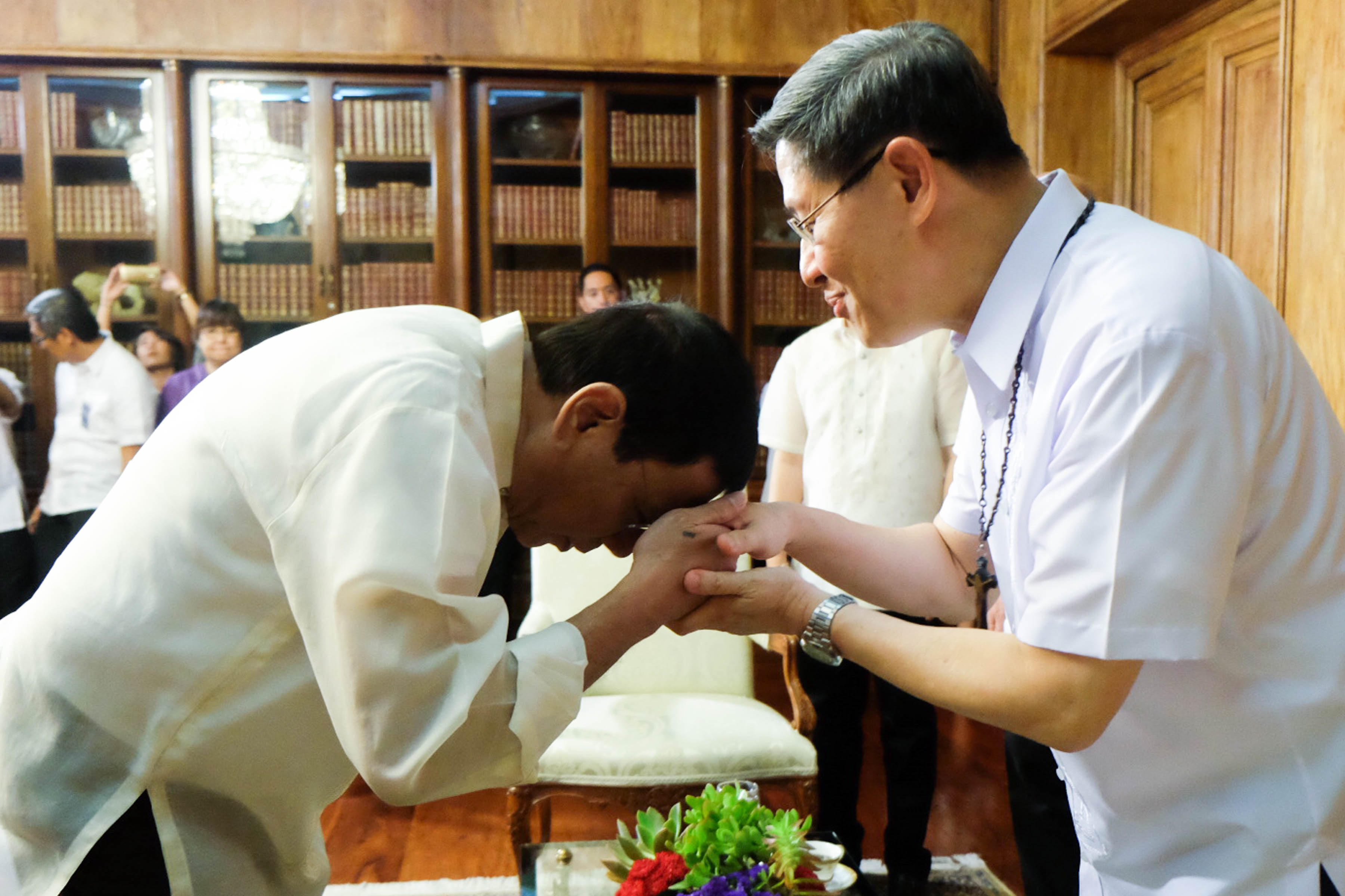 RECONCILIATION? President Rodrigo Duterte places his forehead on Cardinal Luis Antonio Tagle's hand to show respect during a meeting at the Study Room of the Malacañang Palace on Tuesday July 19, 2016. Photo by KIWI BULACLAC/PND 