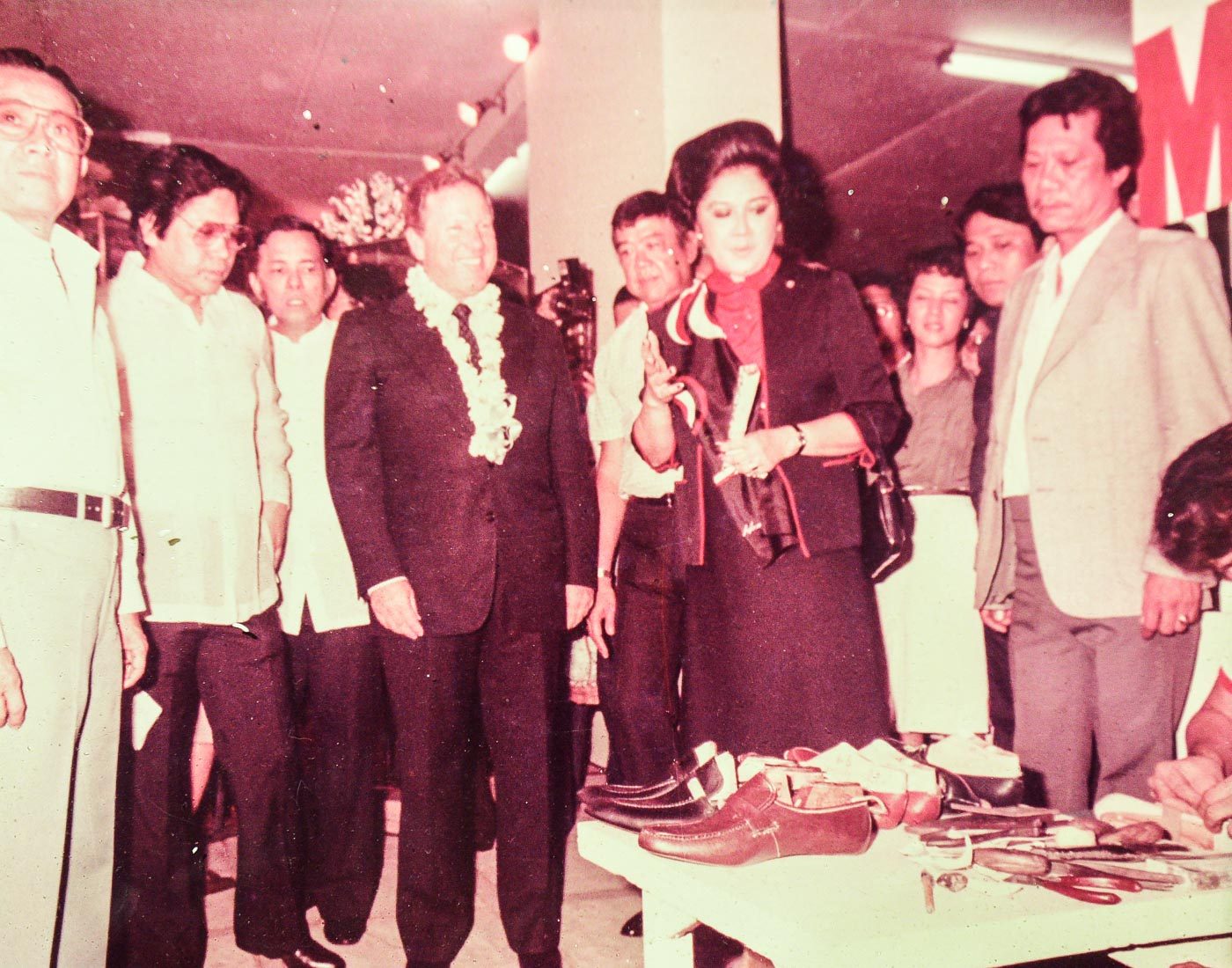 SHOE LOVER. One of the photos featured in the Marikina Shoe Museum shows Imelda Marcos watching a shoemaker. Photo from the Marikina Shoe Museum  