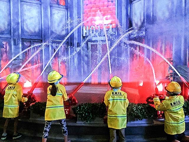 PRACTICE. Holy smokes! Kids actually get to put out a 'real' fire. Photo by Pam Basa Siao 