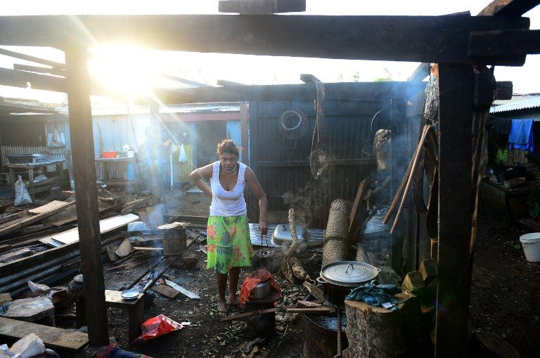 PICKING UP THE PIECES. Residents clean up their homes in Vanuatu's capital Port Vila on March 17, 2015 after Cyclone Pam ripped through the island nation. Jeremy Piper/AFP 