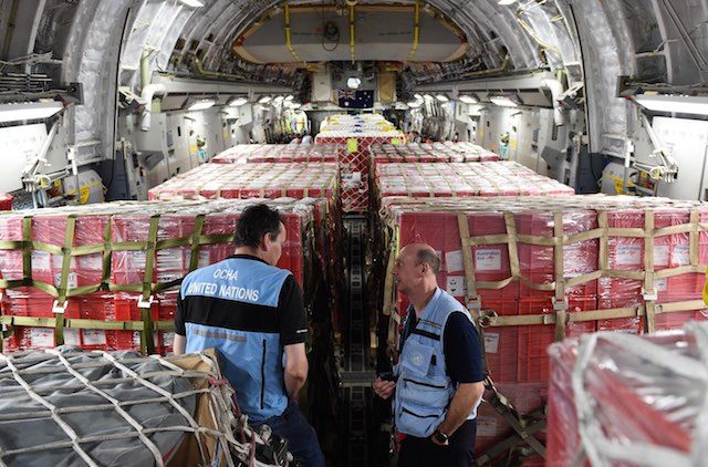 AID ON THE WAY. United Nations personnel are seen amongst aid being flown to Vanuatu's capital Port Villa onboard an RAAF C-17 Globemaster, 16 March 2015. Dave Hunt/EPA 