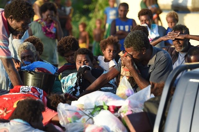 NATION IN MOURNING. People grieve as they transport the body of 20-year-old Eddy Willy on the loading bay of a pickup truck to his burial in the island of Tanna, Vanuatu, on March 17, 2015. Photo by Dave Hunt/EPA  