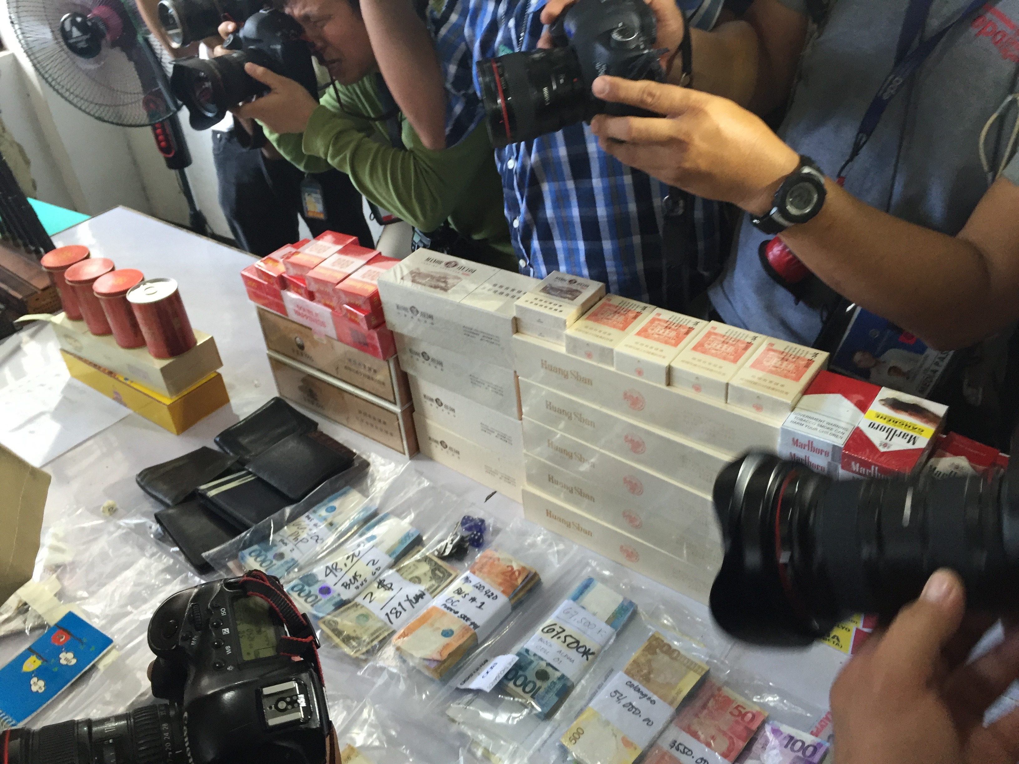 CONFISCATED. Contraband items including cigarettes, crash, and wallets with cash are seized from inmates in the New Bilibid Compound. Photo by Bea Cupin/Rappler   