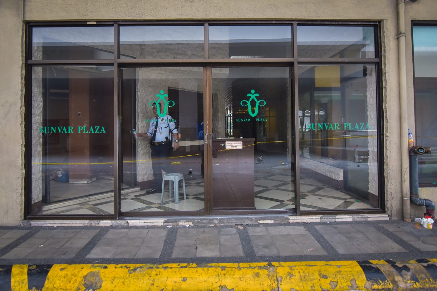 CLOSED. Security guards padlock the entrance of the Sunvar Plaza on August 18, 2017, after the government enforced a vacate order 