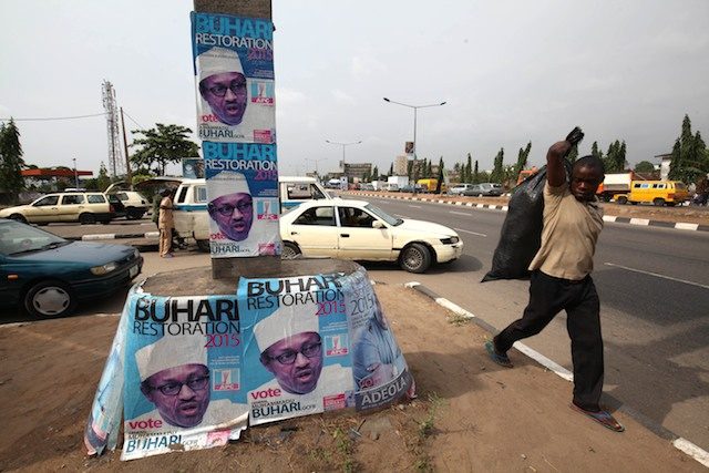 A man walk pass posters of the main opposition presidential candidate, Muhammadu Buhari on a roadside in Ikeja, Lagos, Nigeria, 17 February 2015. Ahmed Jallanzo/EPA 