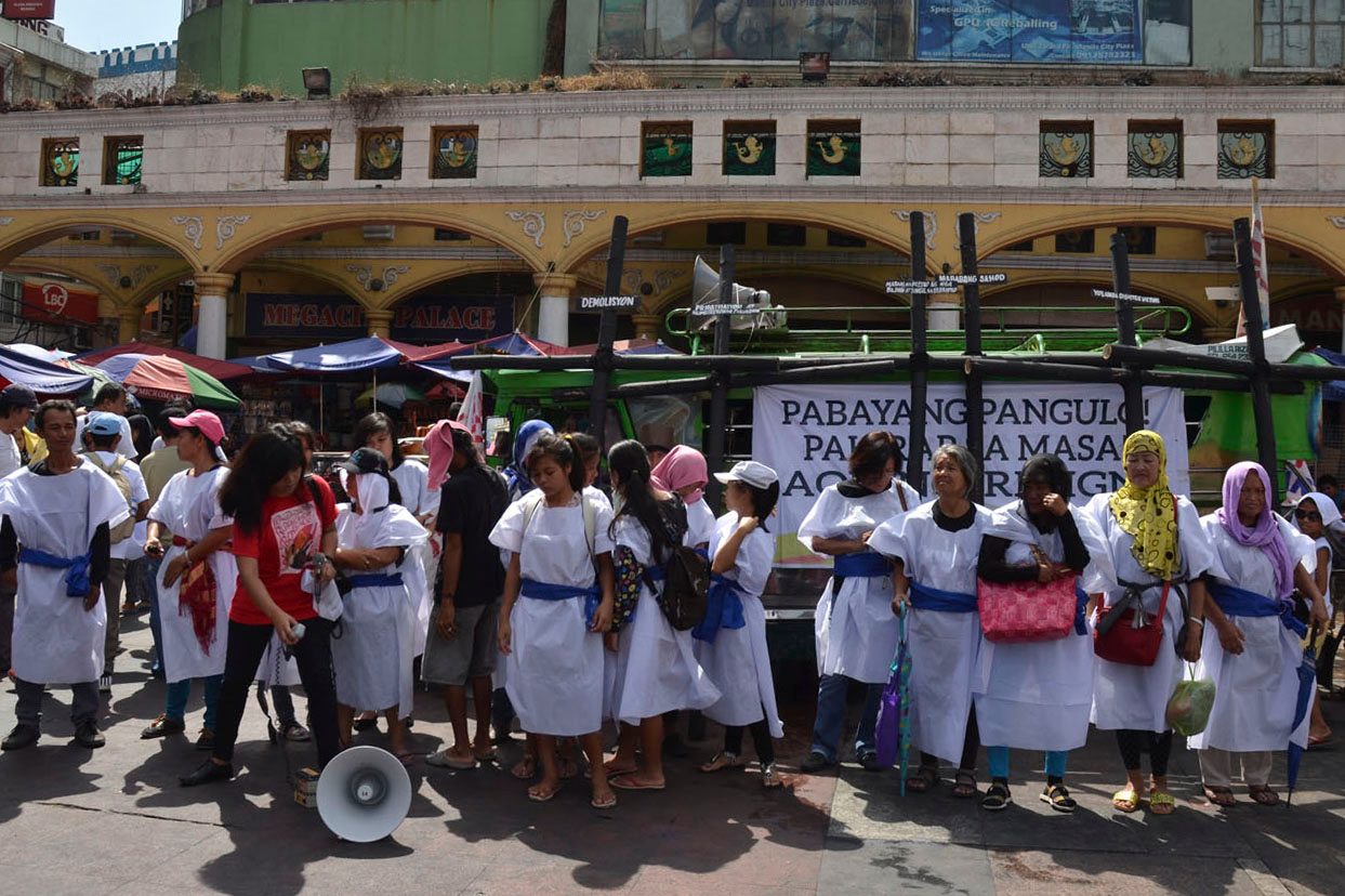 'WOMEN OF GOLGOTHA.' Militant urban poor group KADAMAY gather at the Plaza Miranda to act out the urban poor’s version of the Calvary.  