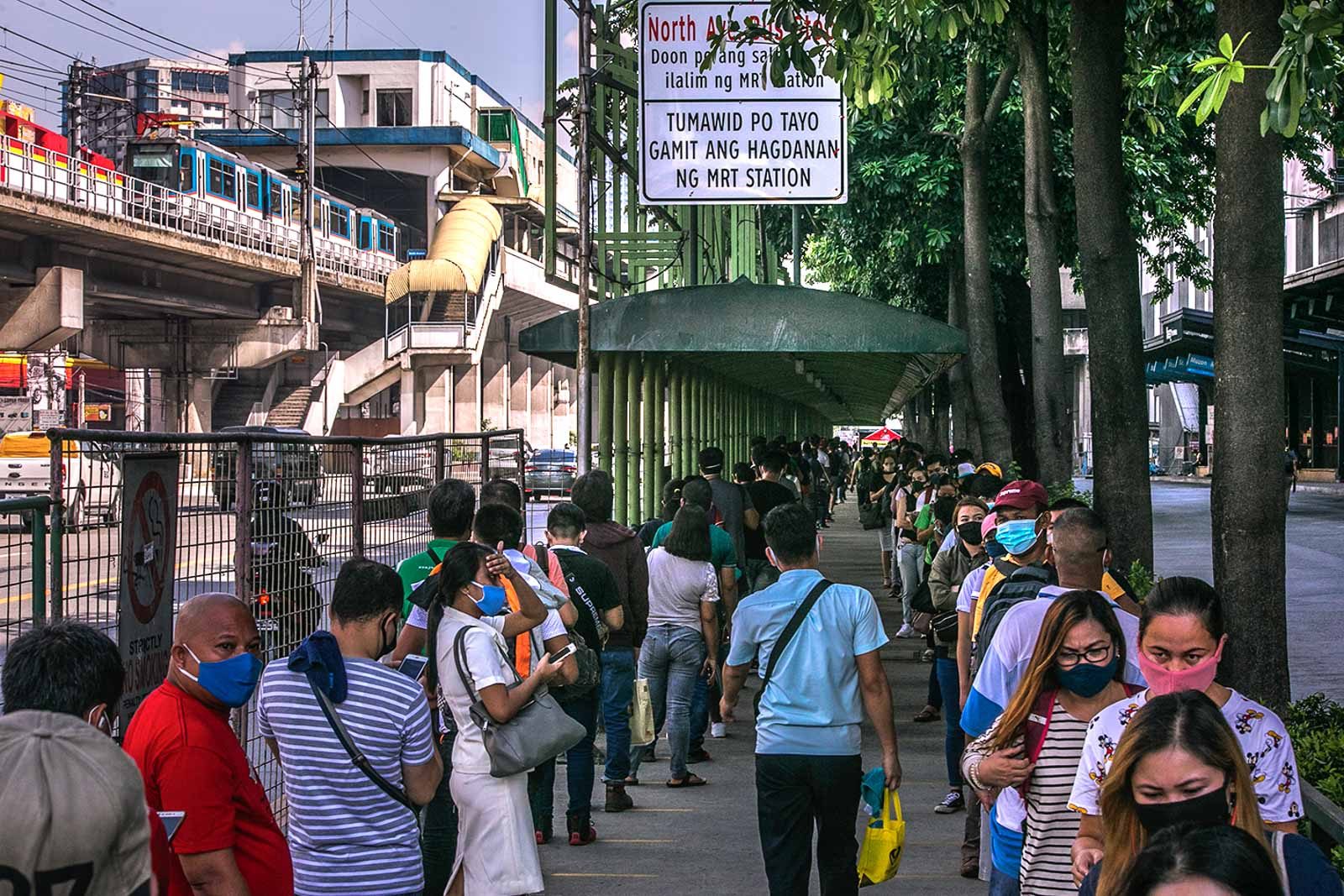 VIRUS THREAT. Hundreds of commuters line up at the MRT-3 Station at North Avenue in Quezon City on June 22, 2020, after the government allows the resumption of modern jeepneys and additional buses. Photo by Darren Langit/Rappler 