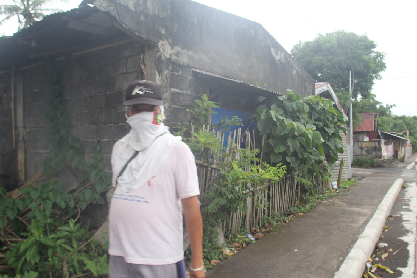 ASHFALL. A man uses a white cloth to cover his mouth and nose in Camalig, Albay amid ashfall from the Mayon Volcano. 