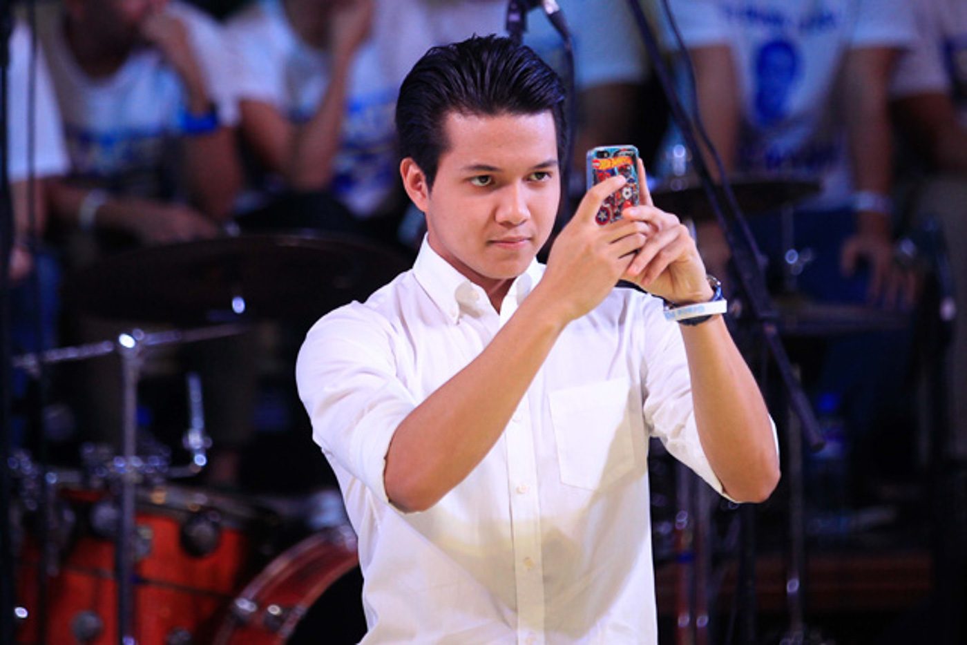 NEWS REPORTER ON LEAVE. Brian Poe Llamanzares takes a photo of his mom, Grace Poe, as she declares her bid for the presidency at the UP Bahay ng Alumni on September 16, 2015. File photo by Czar Dancel/Rappler    