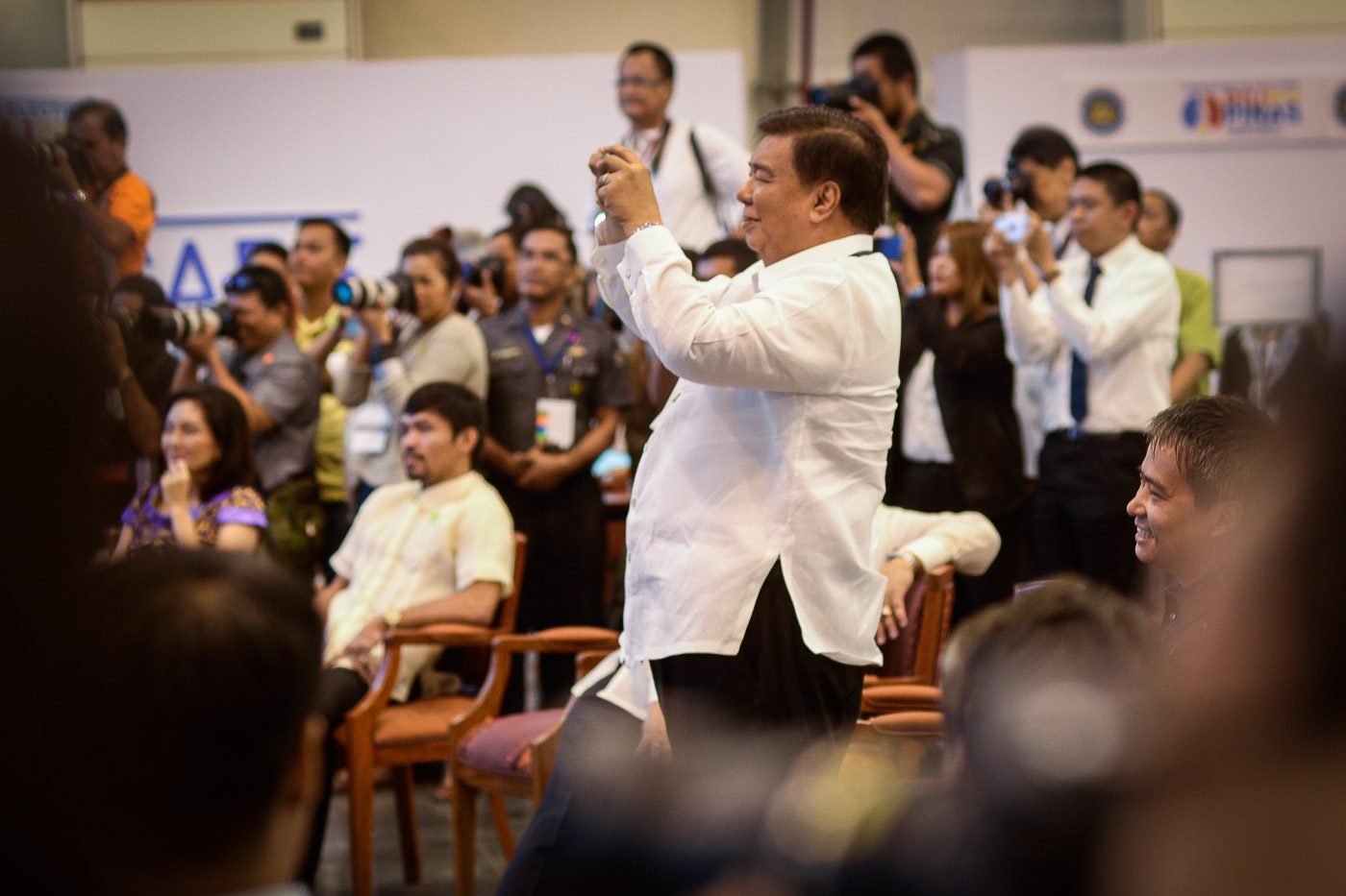 PHOTO BOMBER. The media jeer at Senate President Franklin Drilon twice for obstructing their frame as he takes photos of his newly proclaimed colleagues.  