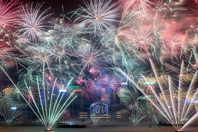 Fireworks explode over Victoria harbour during New Year celebrations in Hong Kong on January 1, 2017. Photo by Dale De la Rey/AFP     