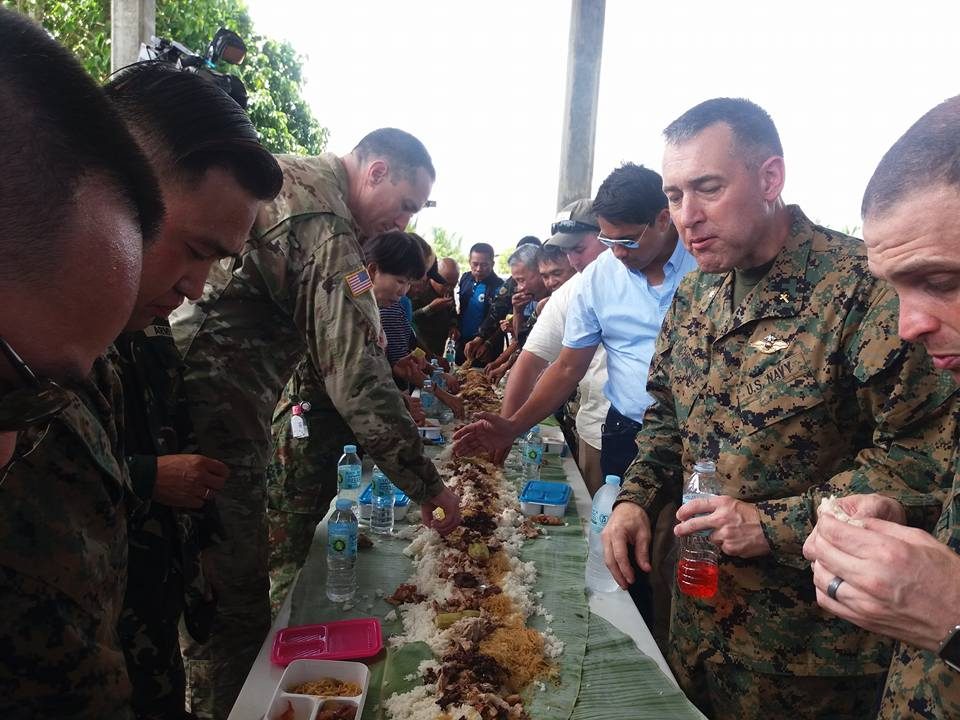 BOODLE FIGHT. Filipino and US soldiers have a boodle fight with local officials in Ormoc City. Photo by Jazmin Bonifacio  