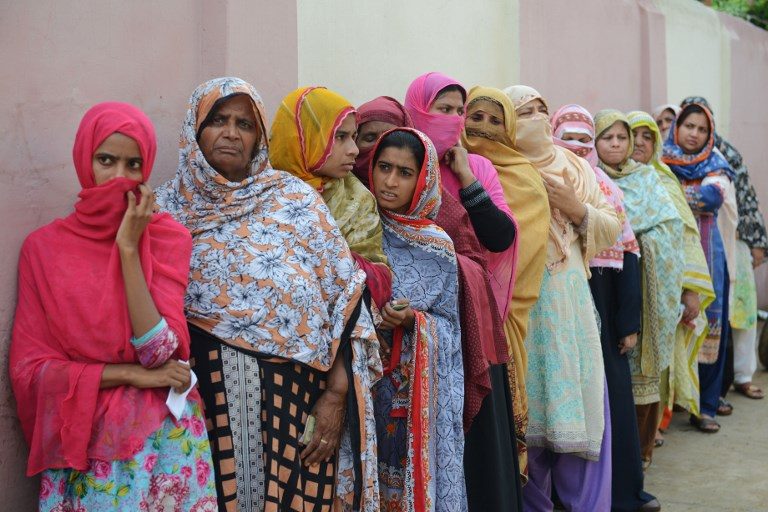 VOTERS. Pakistani women stand in a queue as they wait to cast their vote outside a polling station during general election in Lahore on July 25, 2018. Photo by Arif Ali/AFP  