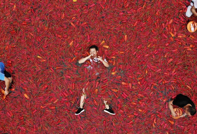 RED HOT. A contestant takes part in a chilli pepper eating competition in Ningxiang in China's central Hunan province on July 8, 2018. Photo by AFP   