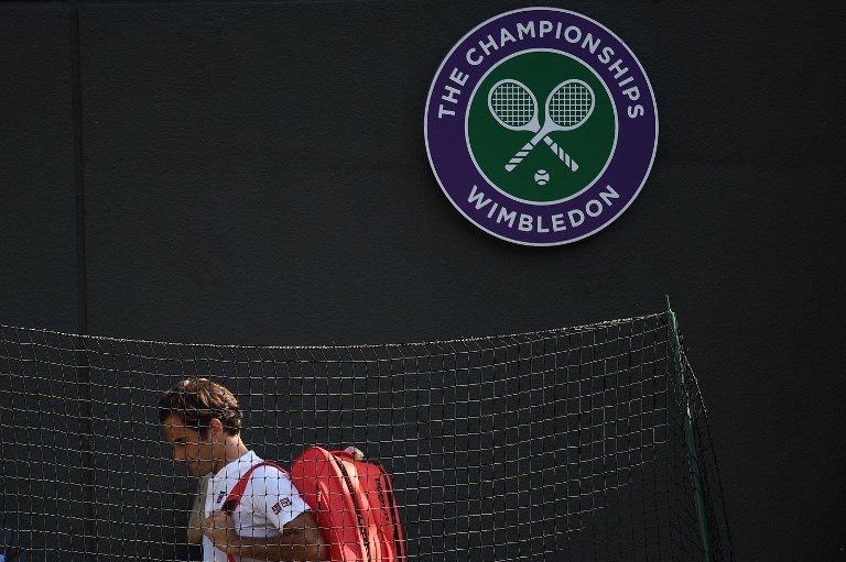 DEJECTED. Switzerland's Roger Federer leaves the court after losing to South Africa's Kevin Anderson in the men's singles quarterfinals match of the 2018 Wimbledon Championships at The All England Lawn Tennis Club in London on July 11, 2018. Photo by Oli Scarff/AFP  