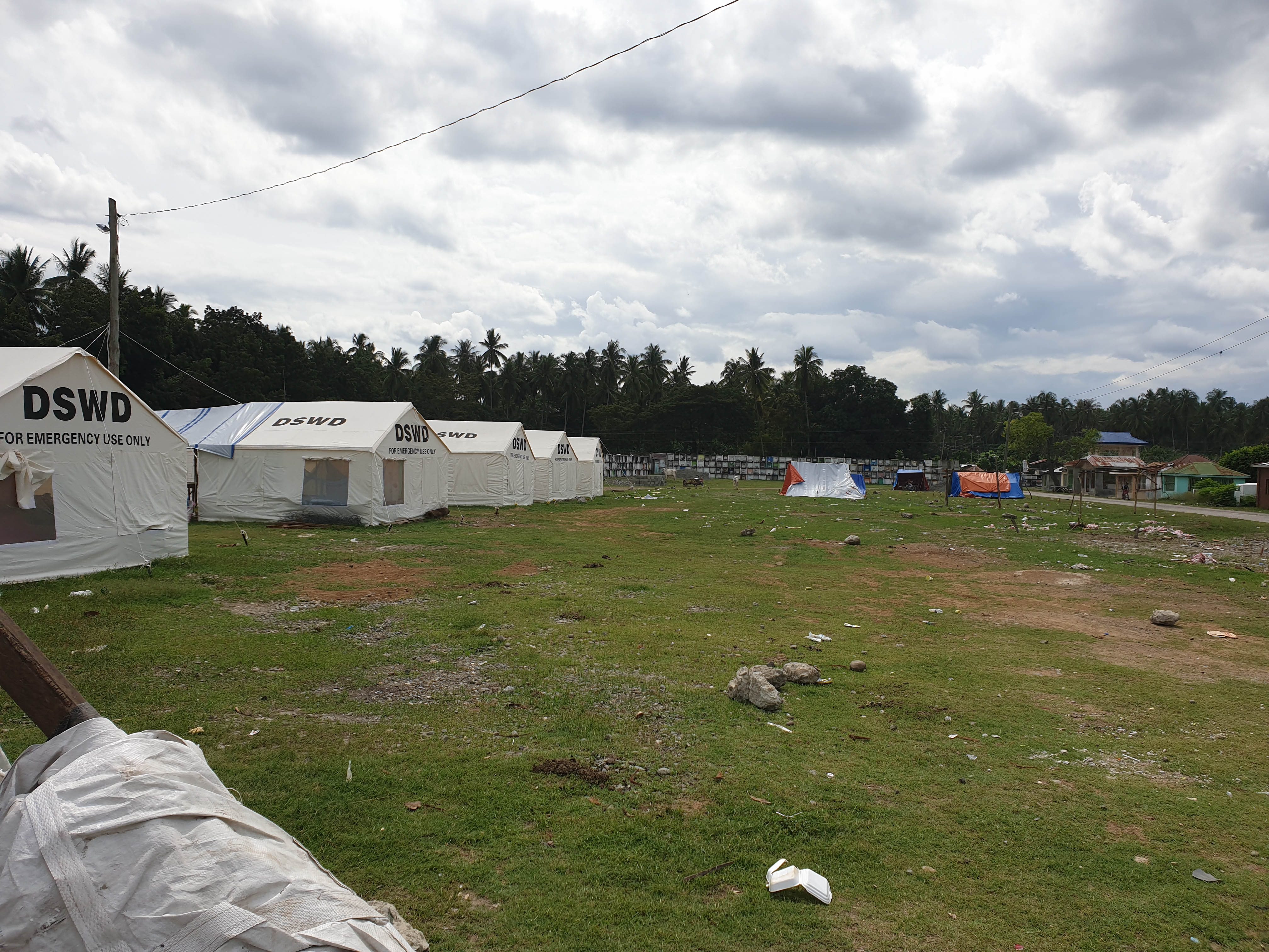 'NEIGHBORS.' Evacuees joke that they are 'living among the dead' because their tents are located inside the Padada public cemetery in Quirino district.  