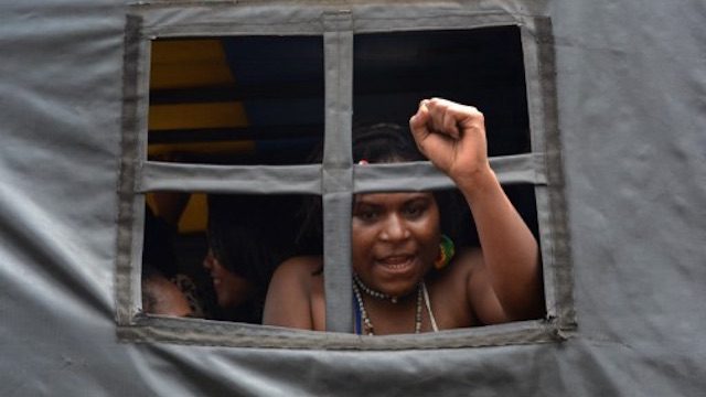 PROTEST. An arrested Papuan pro-independence demonstrator gestures from a police truck in Jakarta on December 1, 2015, after police fired tear gas at a hundreds-strong crowd hurling rocks during a protest against Indonesian rule over the eastern region of Papua. File photo by AFP 
