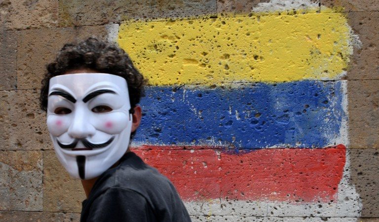 LABOR PROTEST. An activist wearing a Guy Fawkes mask takes part in a march during May Day celebrations in Tegucigalpa, Honduras, on May 1, 2017. Photo by Orlando Sierra/AFP   