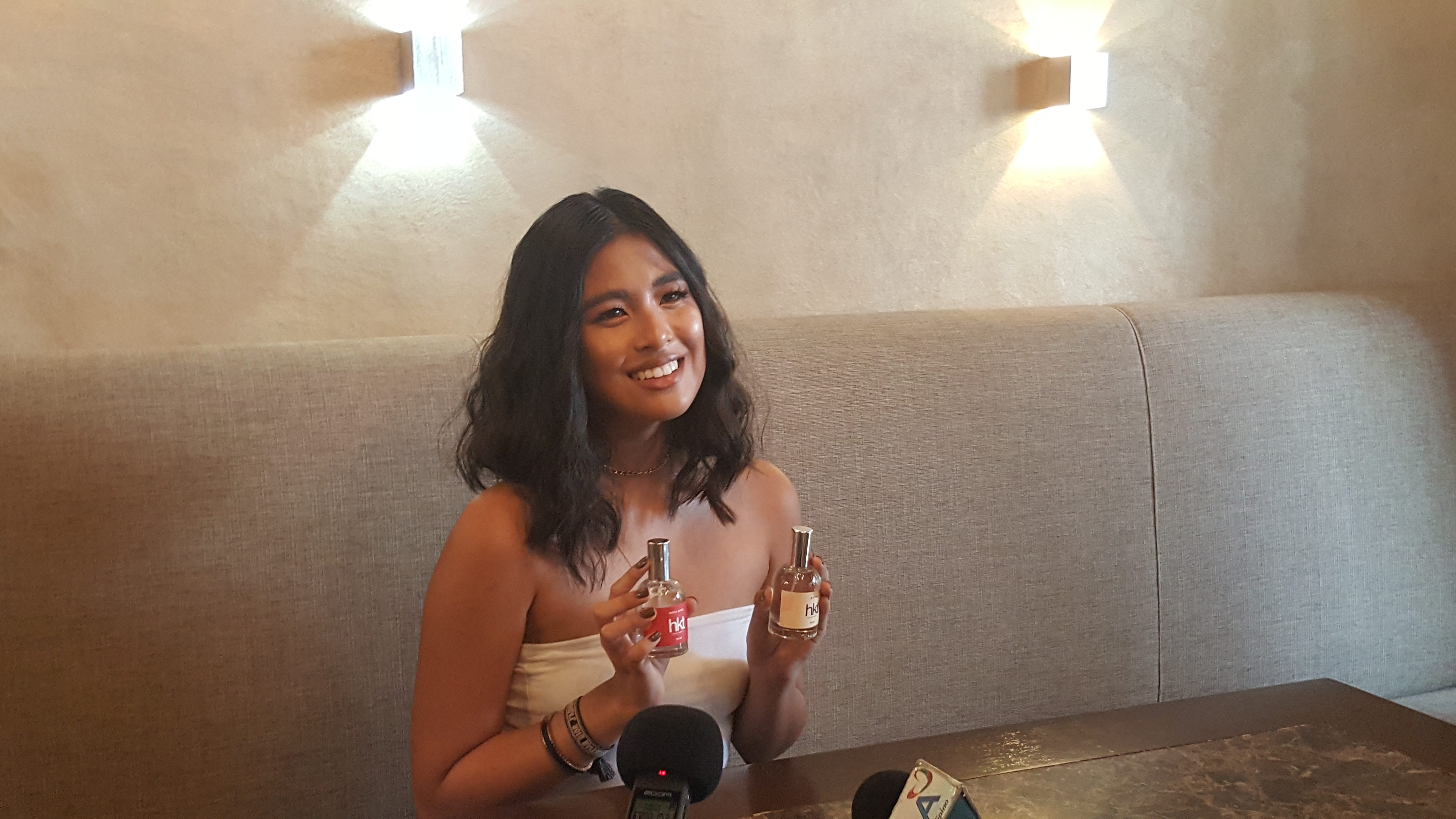 NEW BUSINESS. Gabbi holds two samples of the HKT fragrances as part of the line. Photo by Alexa Villano/Rappler  