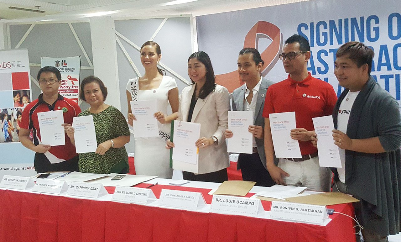 DONE. Catriona, JC show the signed declaration with Taguig mayor Lani Cayetano, Taguig health officials, and representatives of the UNAIDS and Love Yourself groups. Photos by Alexa Villano/Rappler 