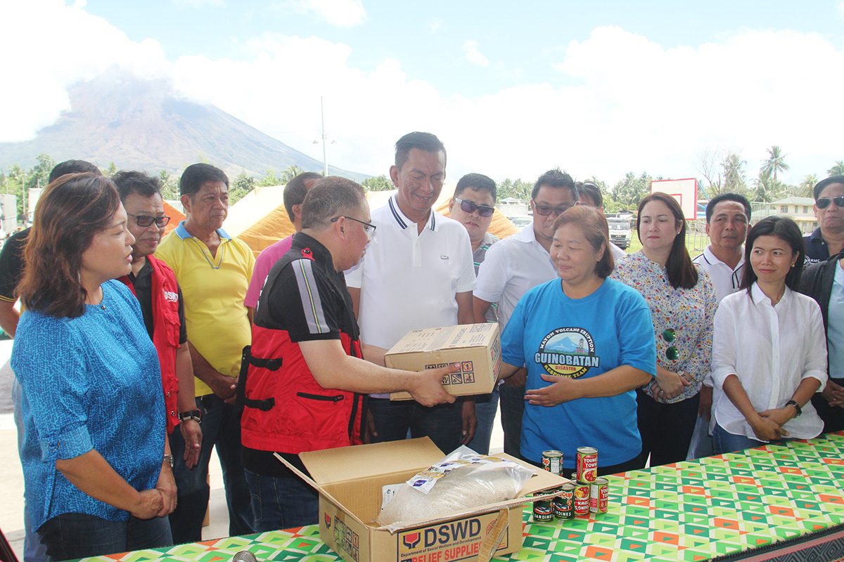 Arnel Garcia, DSWD regional director in Bicol hands over to Mayor Gemma Ongjoco of Guinobatan, Albay food ration intended for Mayon evacuees held at Guinobatan Sports Complex with Rep. Joey Salceda. Photo by Rhaydz Barcia/Rappler 