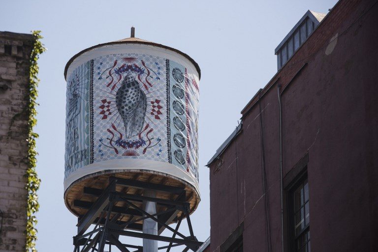 On New York’s rooftops, old-style wooden water tanks hang tough