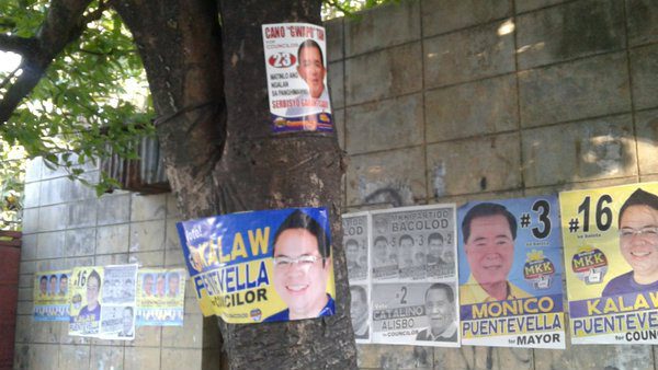 CLEAN AND GREEN? Campaign materials are nailed on trees in the streets of Bacolod City. Photo by Bacolod Mover Claudia Gangayco/Rappler.com  