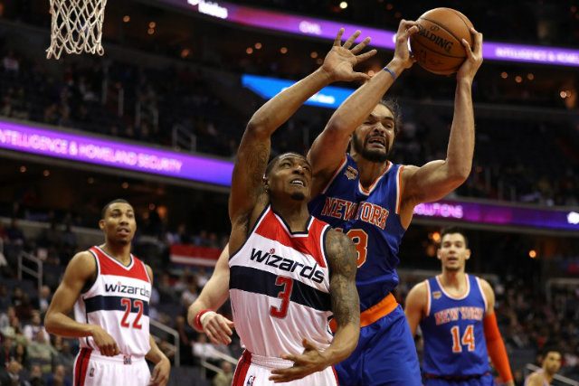 Joakim Noah #13 of the New York Knicks and Bradley Beal #3 of the Washington Wizards battle for a rebound during the first half at Verizon Center on January 31, 2017 in Washington, DC. Patrick Smith/Getty Images/AFP  