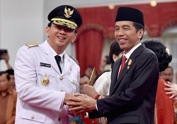 Indonesian President Joko Widodo (right) congratulates Jakarta's new governor Basuki Tjahaja Purnama (left), also known as Ahok, after he was sworn-in at the Palace in Jakarta on November 19, 2014. Photo by Bay Ismoyo/AFP