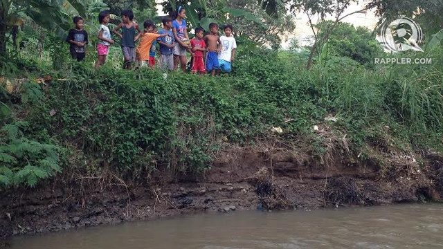 DIRTY WATER. Children in Sitio Cabisig still play near and even in the contaminated stream 