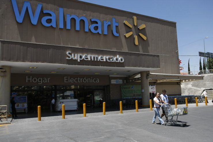 Wal-Mart cuts profit forecast as it gears up e-commerce