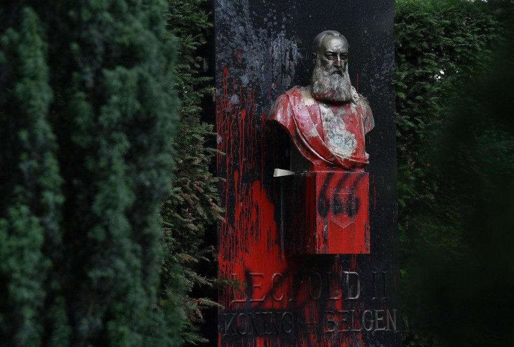 'EVIL TYRANT.' This picture taken on June 30, 2020 shows the vandalized statue of King Leopold II of Belgium, besmirched with red paint in Ghent, Belgium. Photo by John Thys/AFP 
