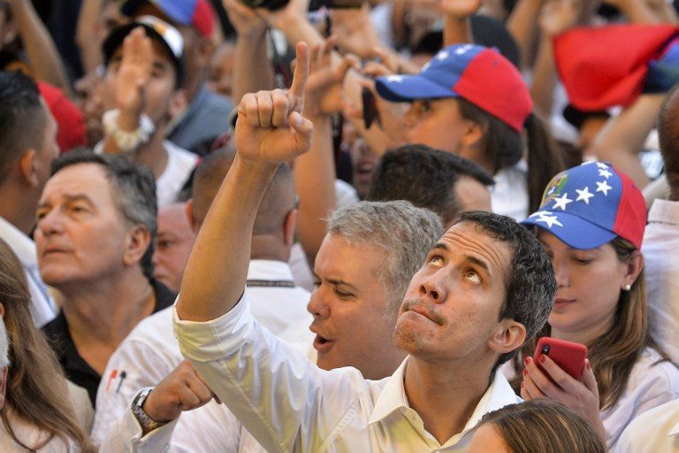 Venezuela’s Guaido defies travel ban as aid row turns deadly